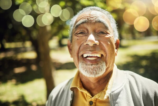 A smiling senior enjoys being outside on a sunny day.