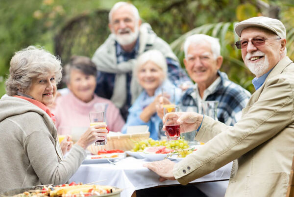 A group of friends dines together at an outdoor picnic