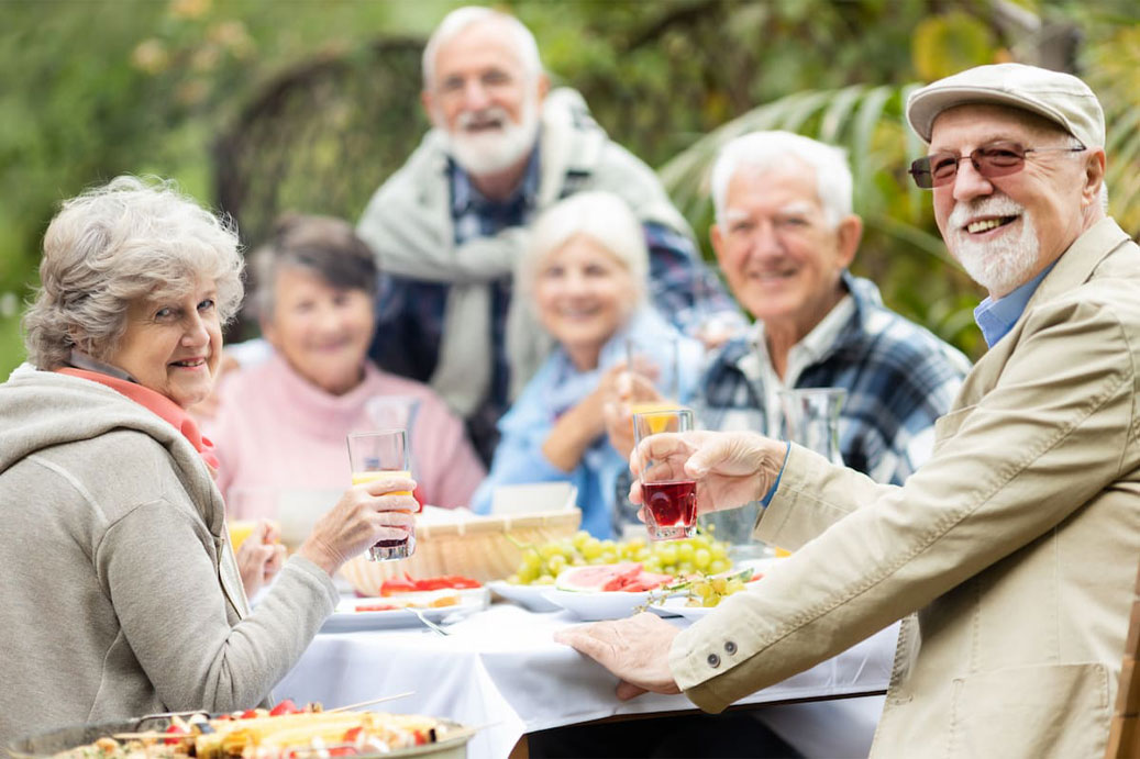 A group of friends dines together at an outdoor picnic