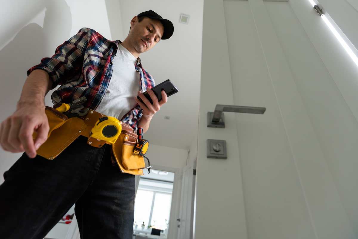 A carpenter repairing a resident's lock