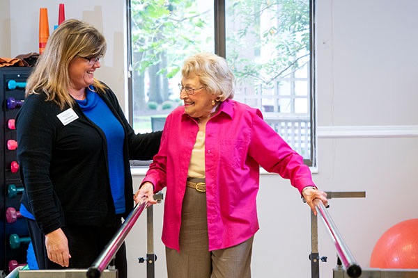 Resident does physical therapy with a team member