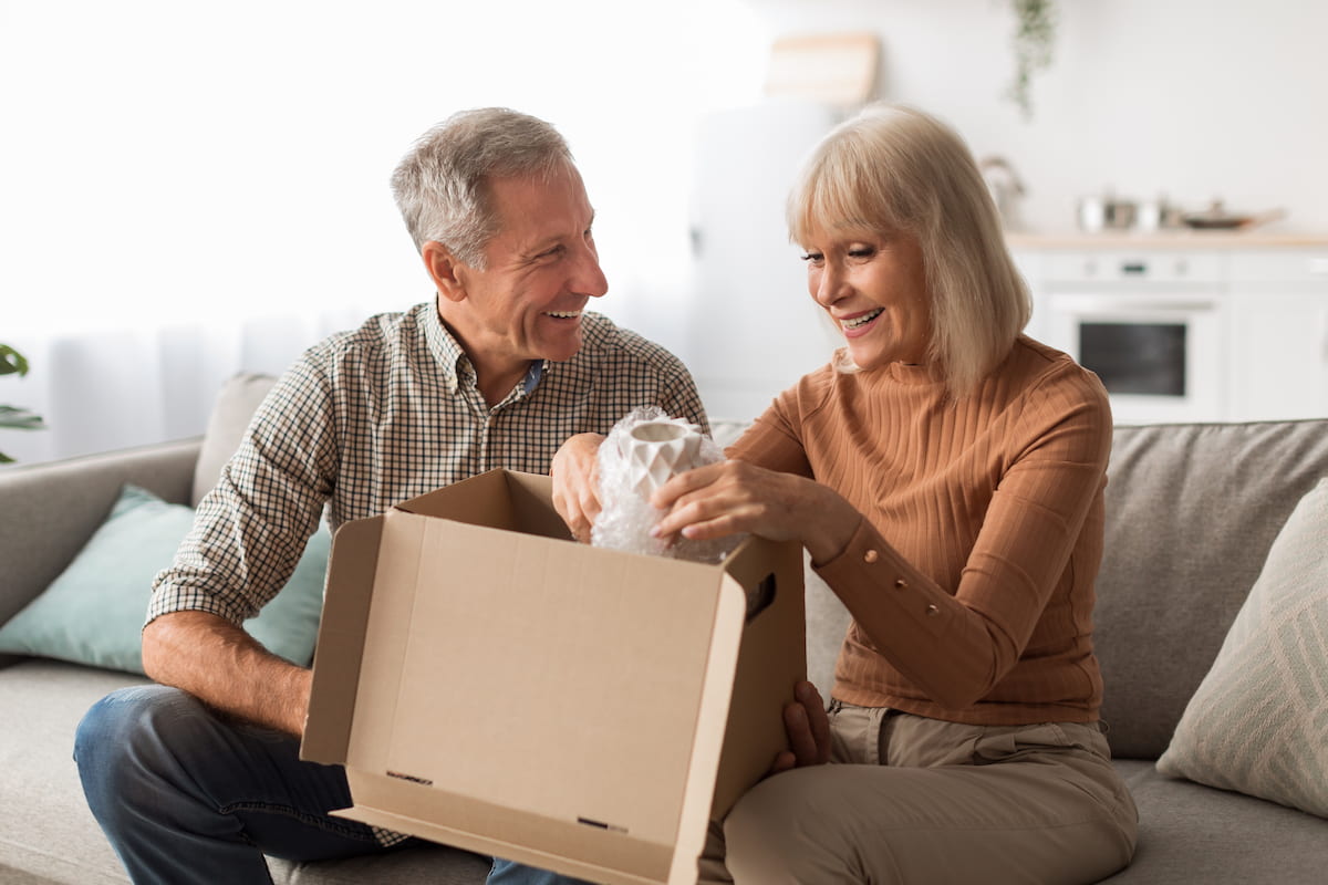 Elderly couple unboxing their belongings