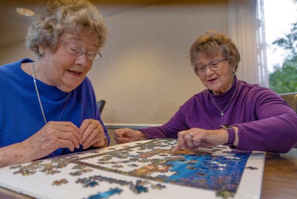 Senior adults working a puzzle