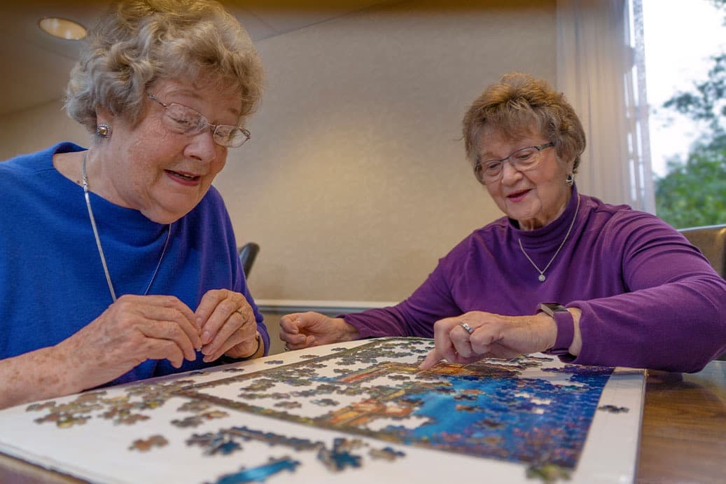 Senior adults working a puzzle